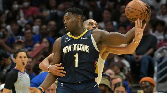 Oct 30, 2022; Los Angeles, California, USA; New Orleans Pelicans forward Zion Williamson (1) keeps the ball out of reach of Los Angeles Clippers forward Nicolas Batum (33) in the second half at Crypto.com Arena.